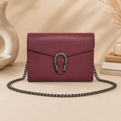 Burgundy leather crossbody bag with decorative front clasp