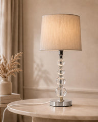 Crystal glass table lamp with silver base and beige fabric shade