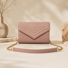 Pink quilted crossbody bag with chevron stitching