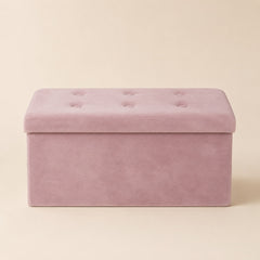 Pink velvet storage bench with tufted lid on a warm beige background