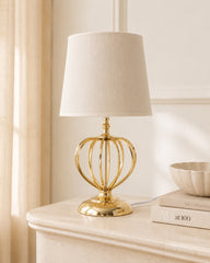 Gold metal table lamp with open decorative base