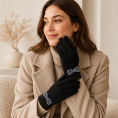 Women’s knitted gloves in black with decorative bow cuffs