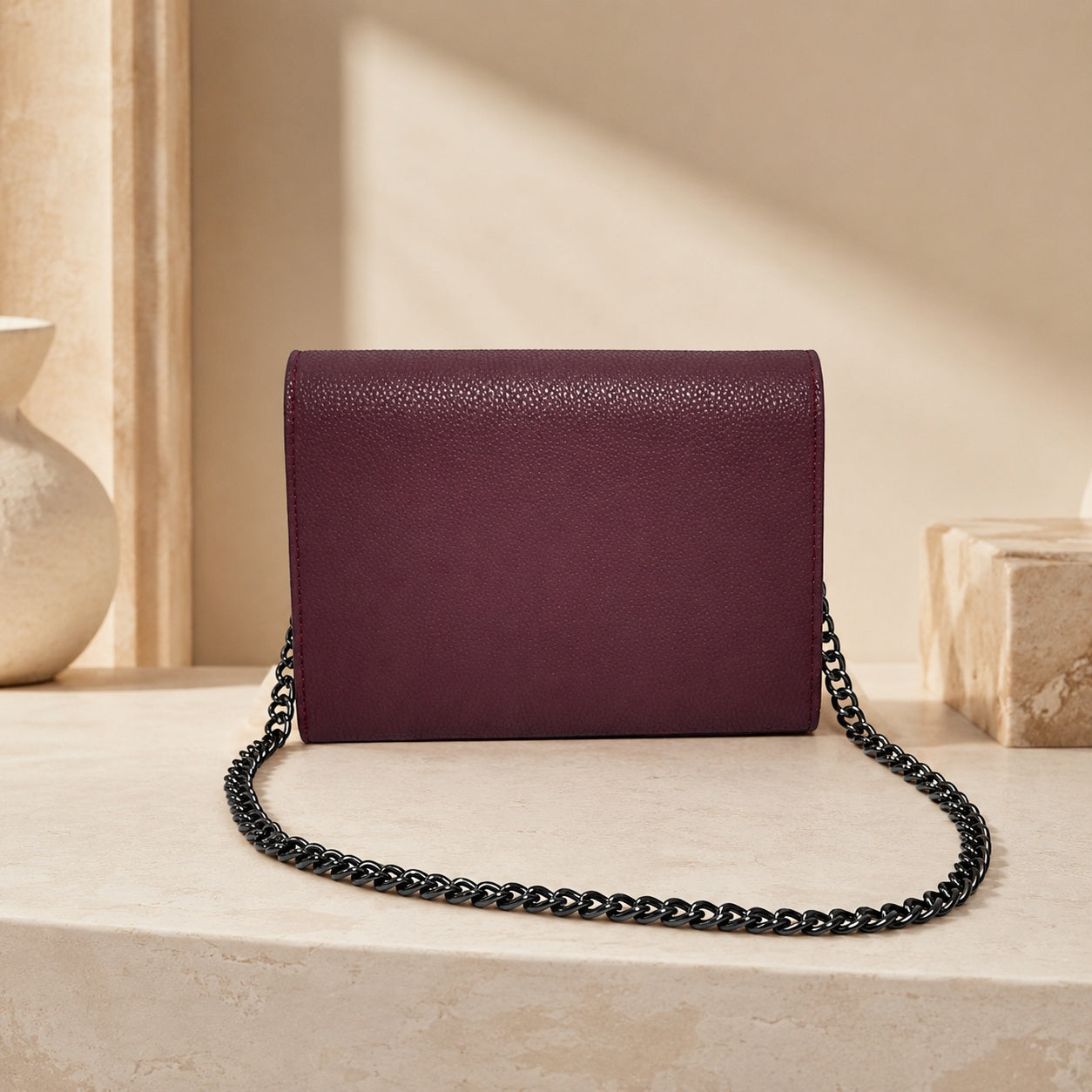 Leather crossbody bag in wine berry with press stud closure