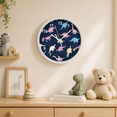 Blue dinosaur wall clock in a softly styled children’s room with wooden furniture and plush toys
