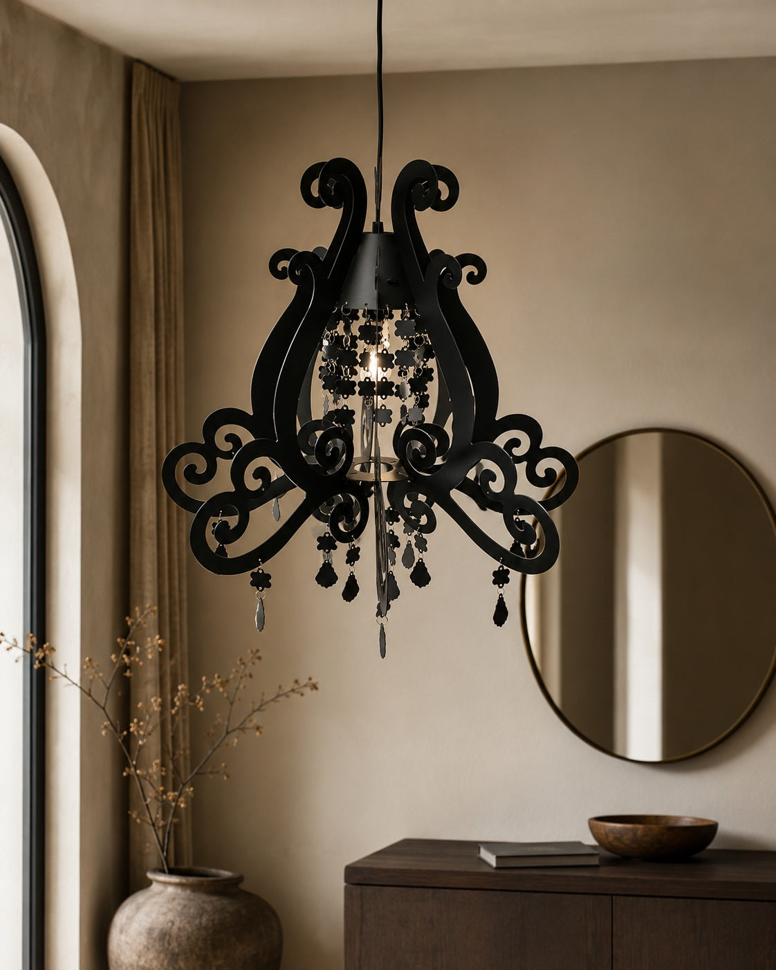Black ornate pendant light with scrollwork and hanging details