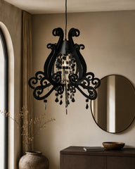 Black ornate pendant light with scrollwork and hanging details
