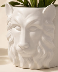 White ceramic planter with sculpted lion head design