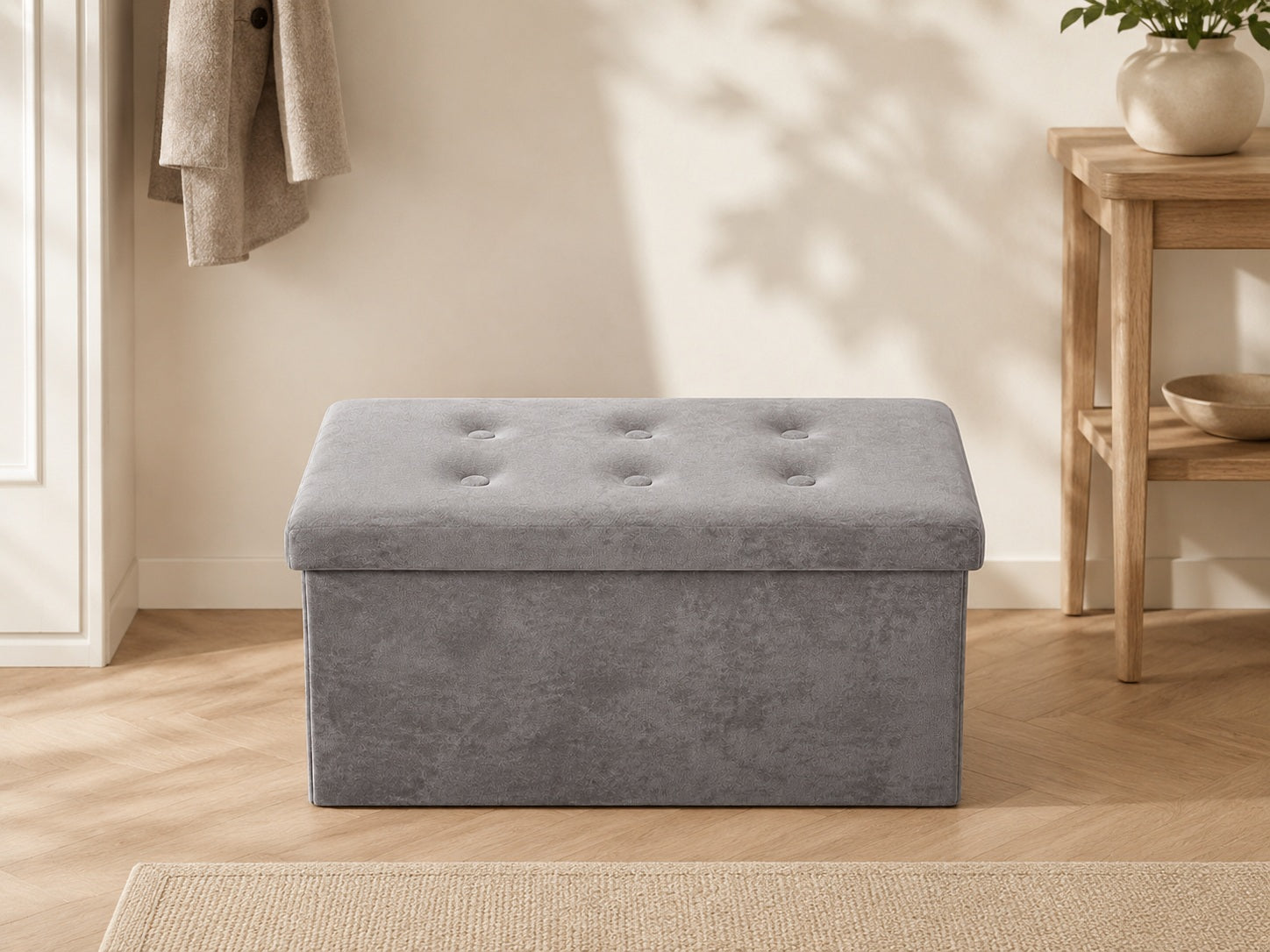 Grey velvet storage bench in a calm neutral hallway interior
