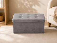 Grey upholstered storage bench in a minimalist living room