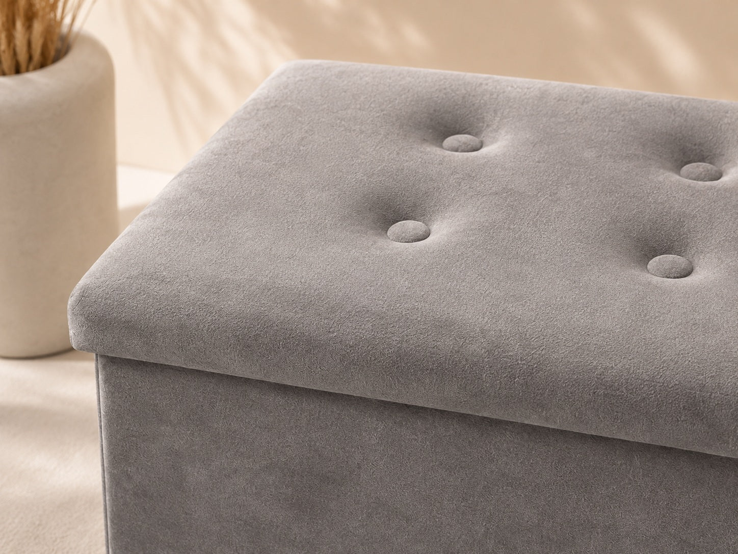 Close-up of grey velvet upholstery and tufted button details