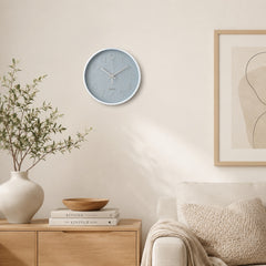 Grey wall clock with white frame in a warm neutral living room