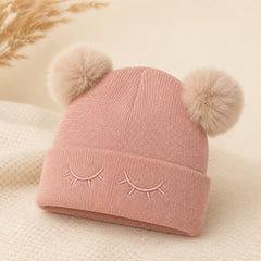 Roze knitted kinderen winter muts met embroidered sleepy eyes