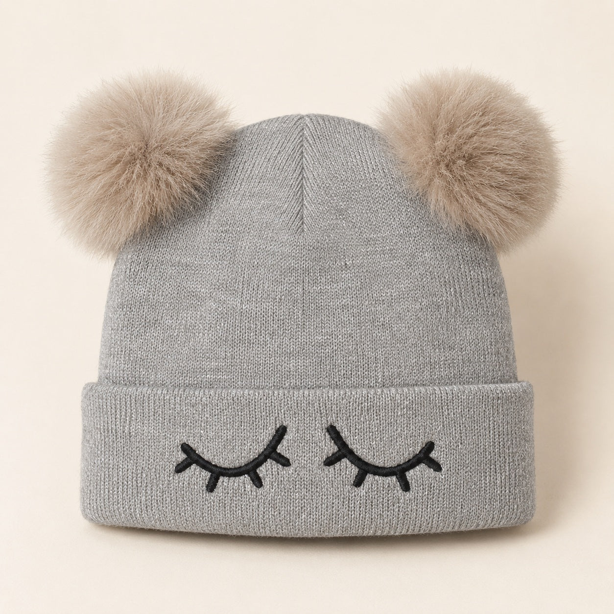 Grey knitted winter hat for kids with black eyelash embroidery