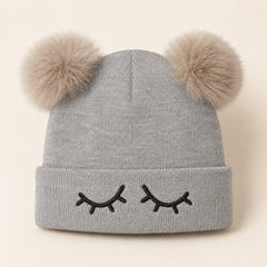 Grey knitted winter hat for kids with black eyelash embroidery