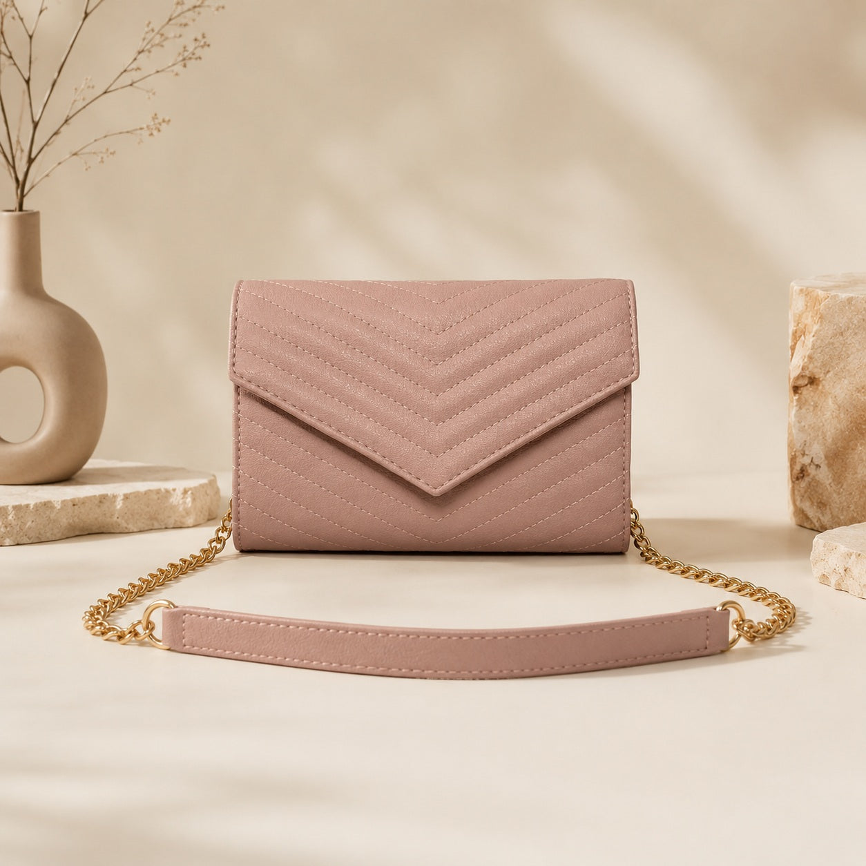 Pink quilted crossbody bag with chevron stitching