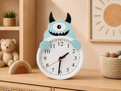 Wooden kids clock with white face and baby blue monster design