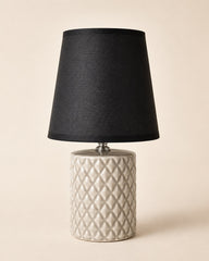 Modern bedside table lamp with black lampshade and beige ceramic base