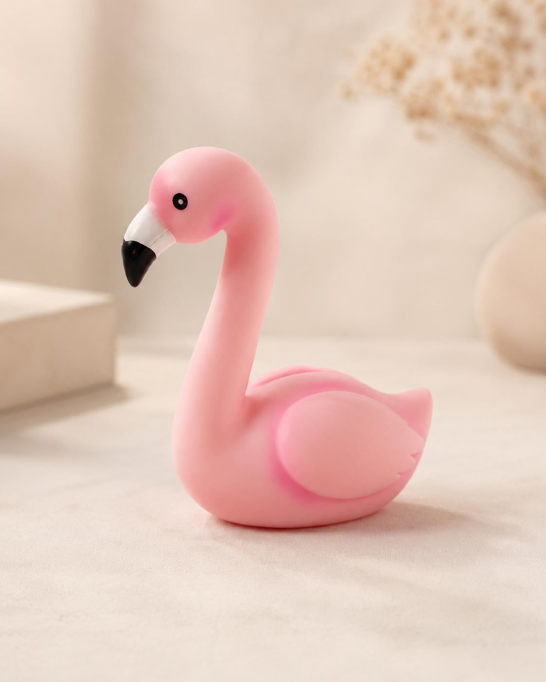 Small pink battery-powered flamingo lamp in beige interior