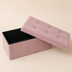 Open pink velvet storage bench with removable lid and black interior