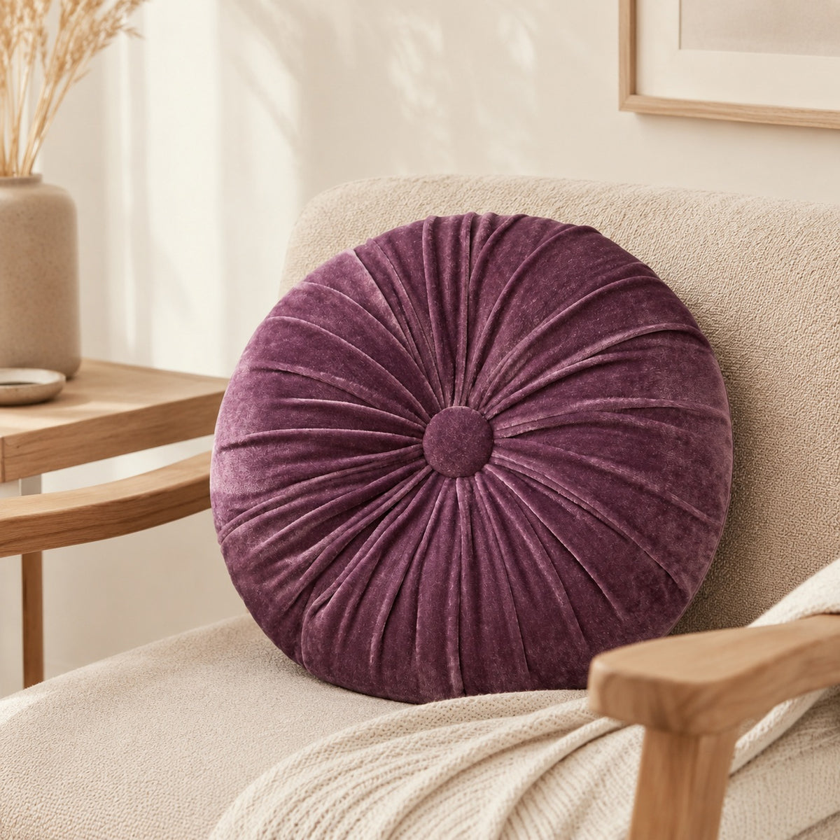 Rindy purple round cushion styled on a beige armchair in a calm living room