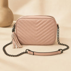 Old pink quilted crossbody bag with black chain strap