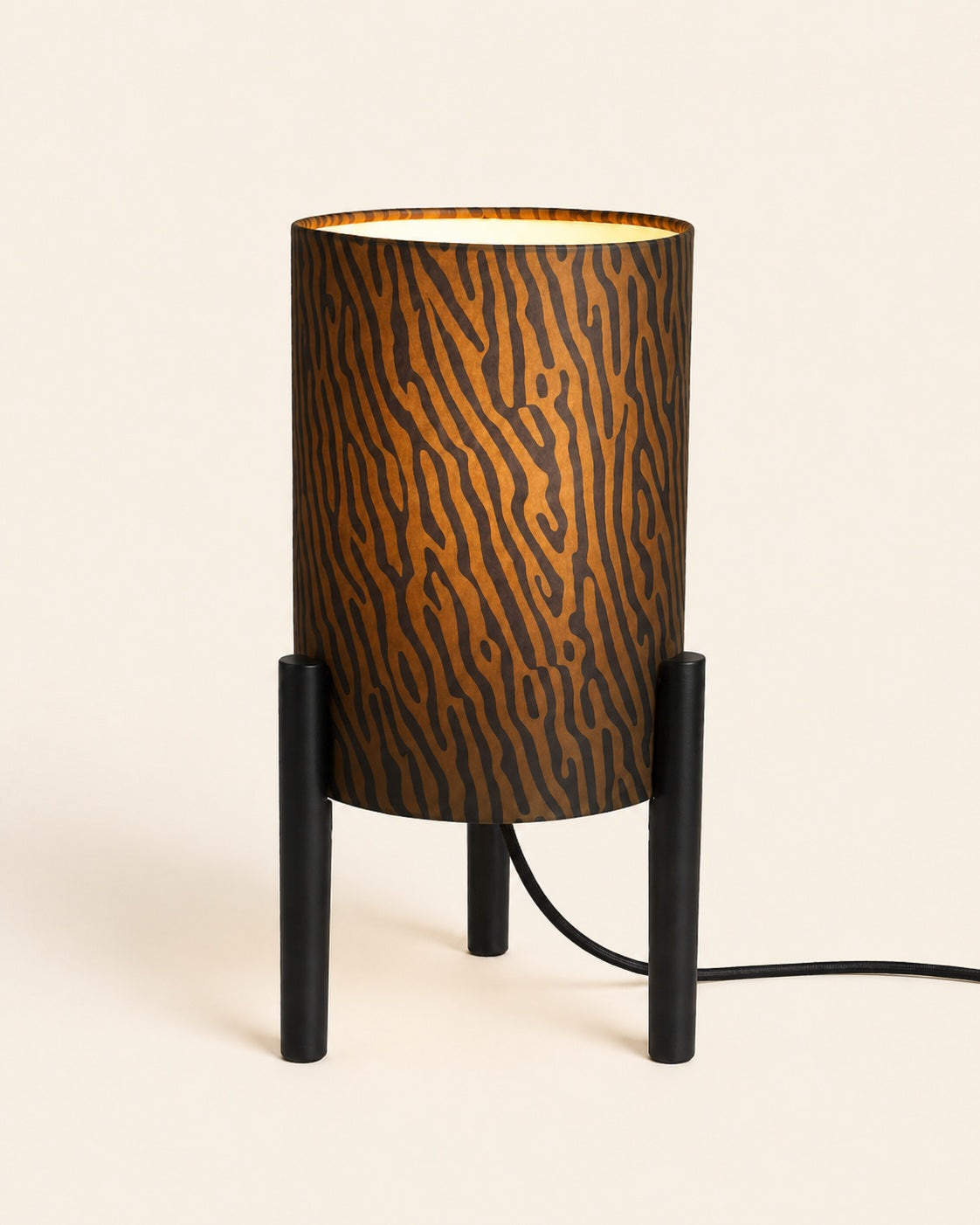 Compact black table lamp with three-legged base