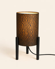 Compact black table lamp with three-legged base