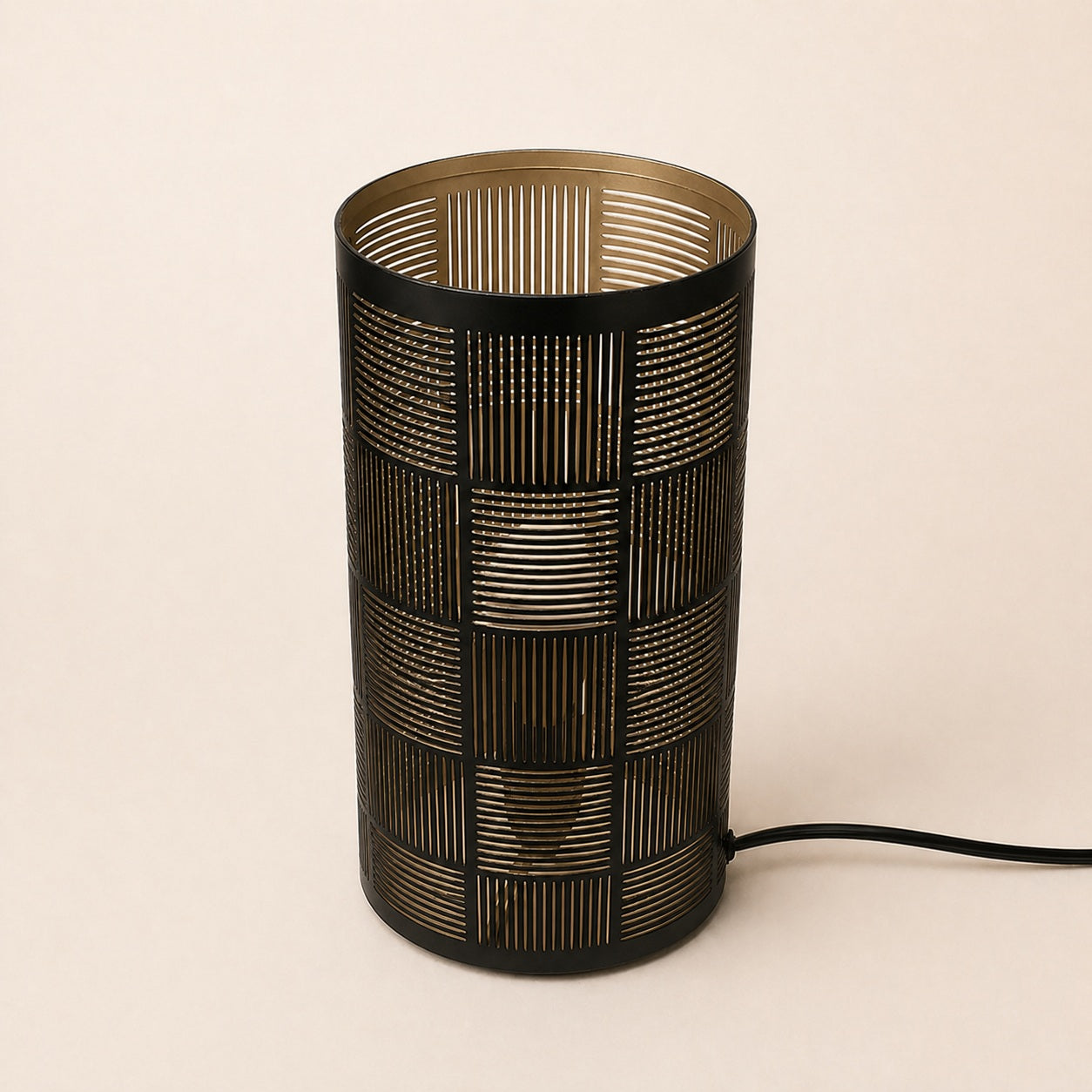 Santio patterned cylinder lamp creating warm light effect