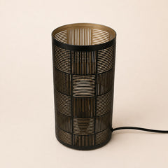 Santio patterned cylinder lamp creating warm light effect