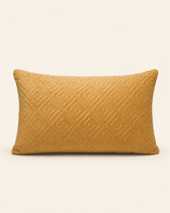 Mustard yellow velvet cushion with geometric pattern detail