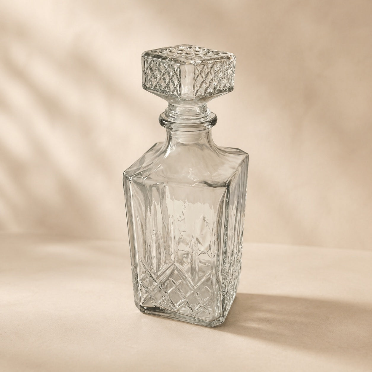 Clear glass whiskey decanter with cut-look stopper